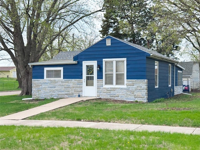 2003 Carroll St, Boone, IA 50036 - bungalow featuring roof with shingles, fence, a front yard, and stone siding