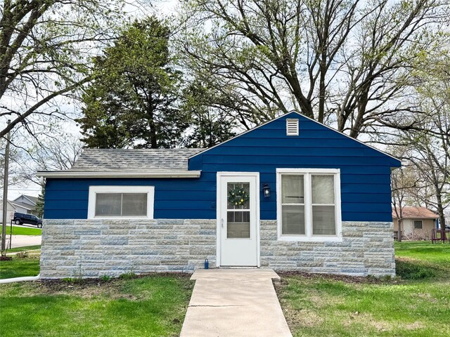 2003 Carroll St, Boone, IA 50036 - bungalow with a shingled roof, a front lawn, and stone siding