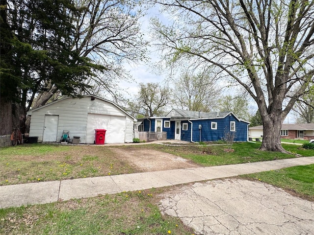 2003 Carroll St, Boone, IA 50036 - ranch-style house featuring an outbuilding, a front lawn, driveway, and a detached garage