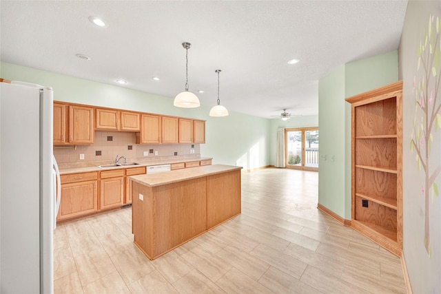 kitchen with a kitchen island, sink, backsplash, white appliances, and pendant lighting