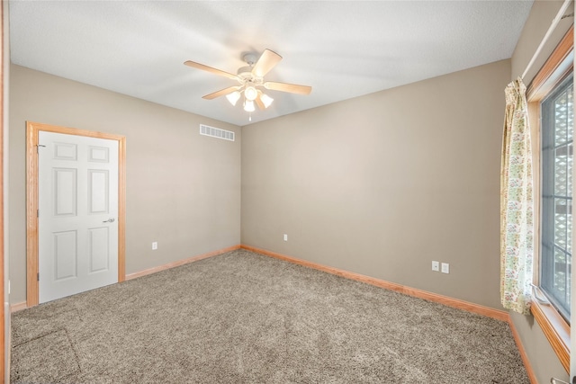 carpeted empty room with ceiling fan