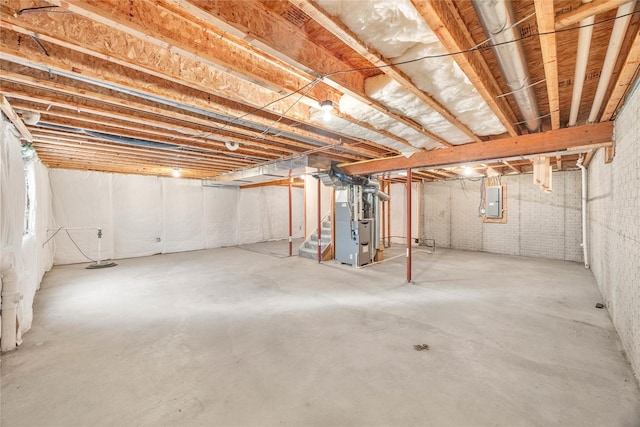 basement with electric panel and heating unit