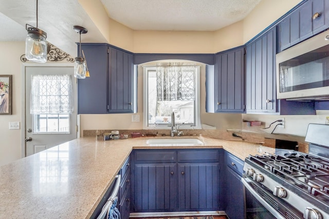 kitchen featuring sink, blue cabinets, and stainless steel appliances