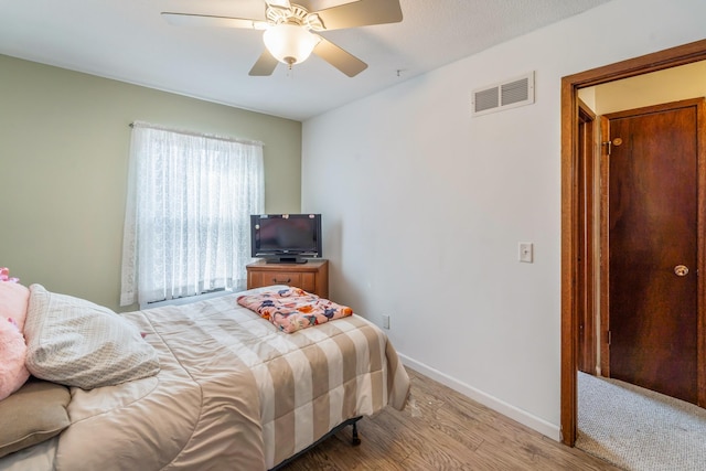 bedroom featuring hardwood / wood-style flooring and ceiling fan