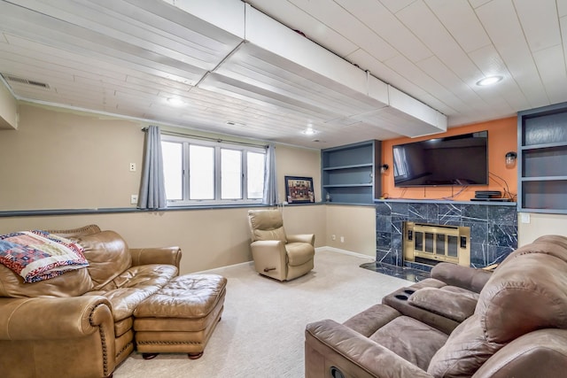 carpeted living room with a high end fireplace and wooden ceiling