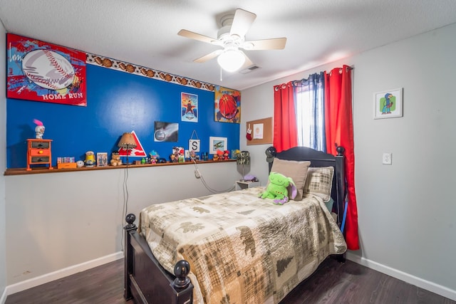 bedroom featuring ceiling fan, dark hardwood / wood-style flooring, and a textured ceiling