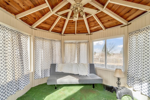 interior space featuring ceiling fan, wooden ceiling, and lofted ceiling with beams