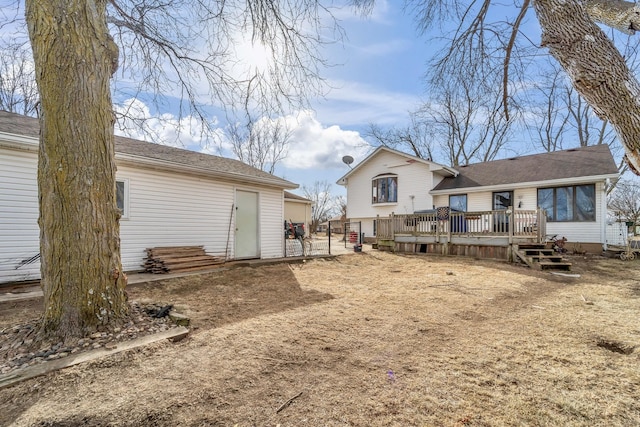 rear view of property with a wooden deck