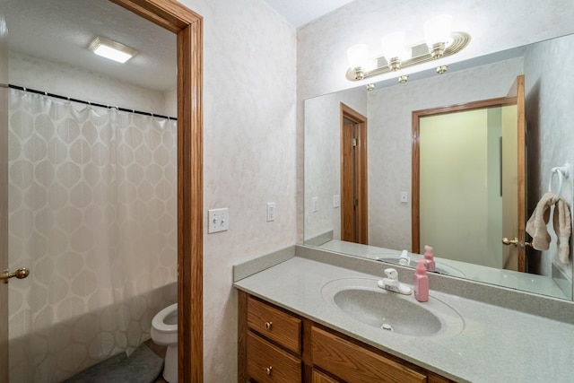 bathroom featuring toilet, a shower with curtain, and vanity