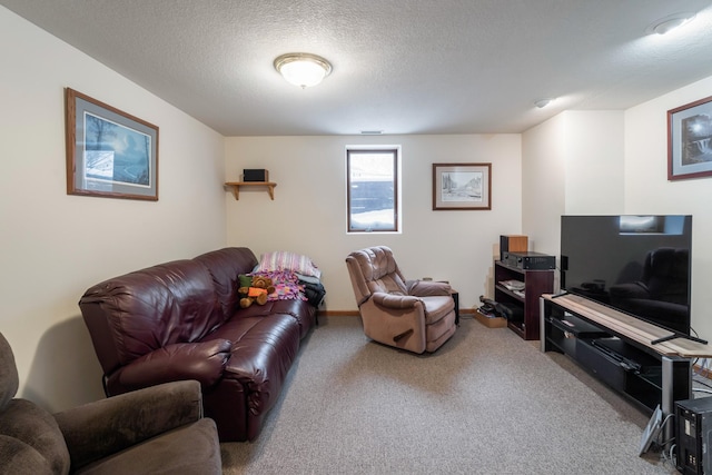 carpeted living room featuring a textured ceiling