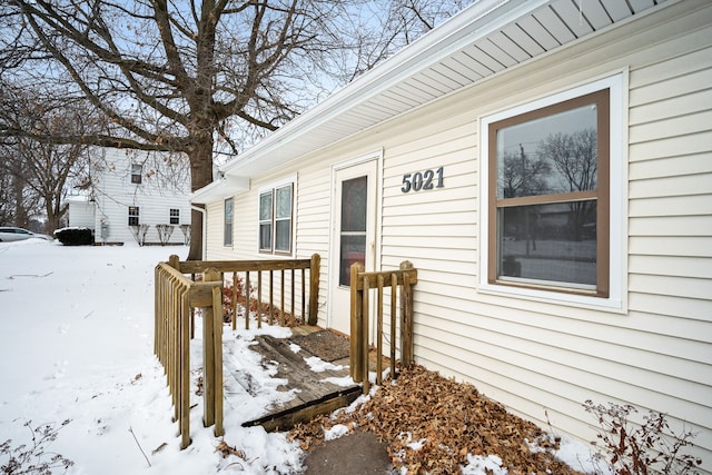 view of snow covered property entrance