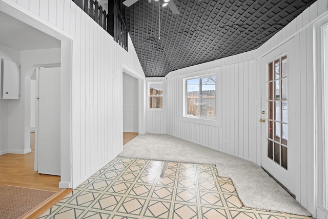 interior space featuring ceiling fan and lofted ceiling