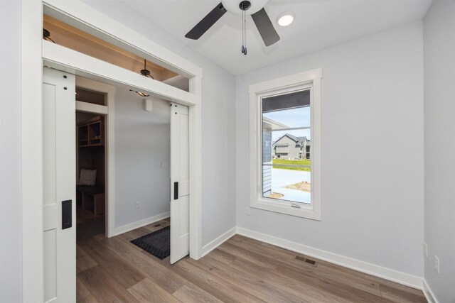 18274 Hidden Knl, Clive, IA 50325 - spare room with wood finished floors, baseboards, and ceiling fan