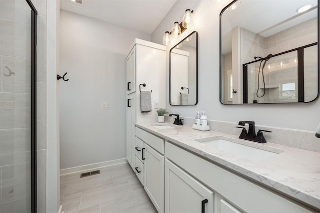18274 Hidden Knl, Clive, IA 50325 - bathroom with a shower stall, double vanity, and baseboards