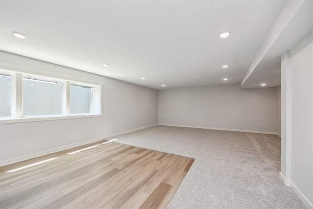 18274 Hidden Knl, Clive, IA 50325 - basement featuring recessed lighting, baseboards, light wood-type flooring, and light colored carpet
