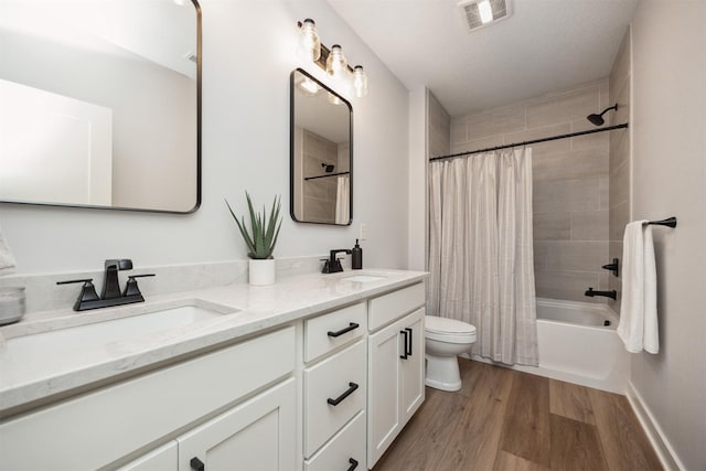 18274 Hidden Knl, Clive, IA 50325 - full bathroom featuring wood finished floors, double vanity, toilet, and shower / bath combination with curtain