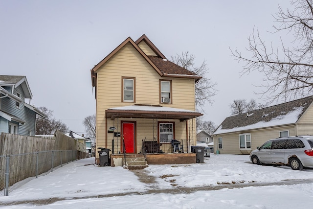 view of front facade with fence and covered porch