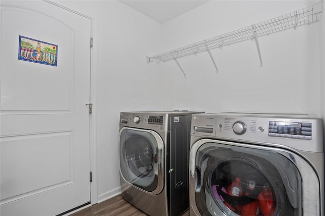 laundry room featuring laundry area, separate washer and dryer, and dark wood-type flooring