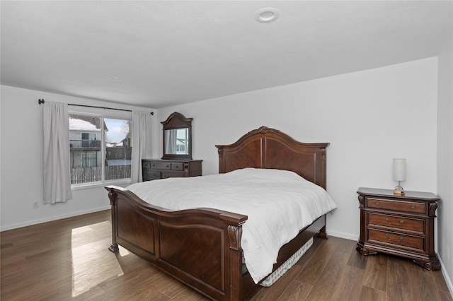 bedroom featuring dark wood-style floors and baseboards