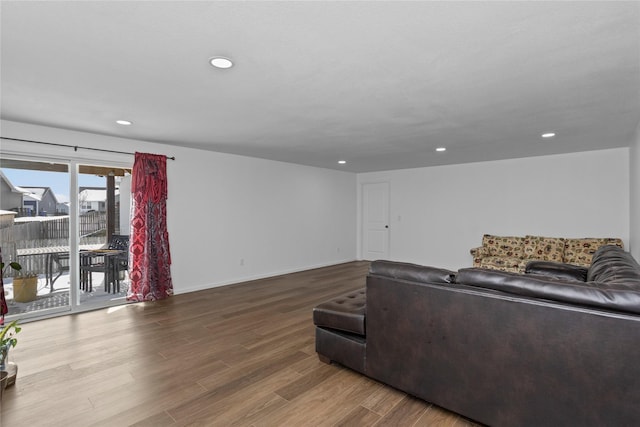 living room with baseboards, wood finished floors, and recessed lighting