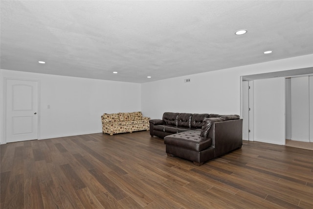 living area featuring visible vents, dark wood-type flooring, and recessed lighting