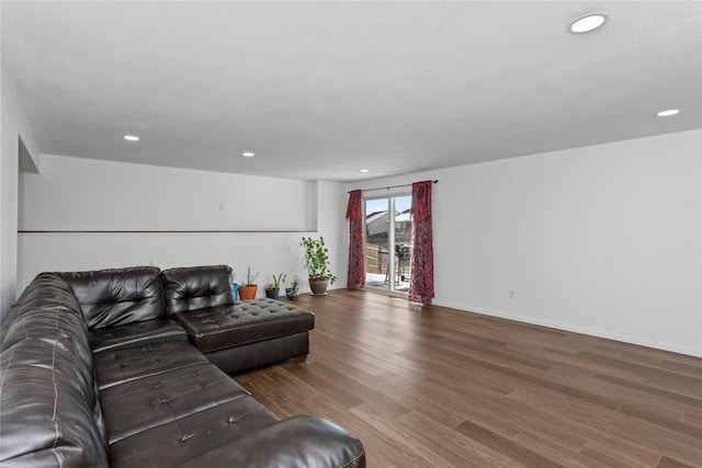 living room with baseboards, wood finished floors, and recessed lighting