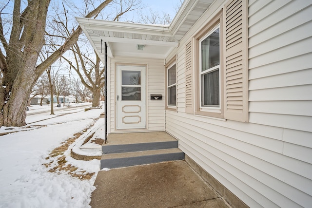 view of snow covered property entrance