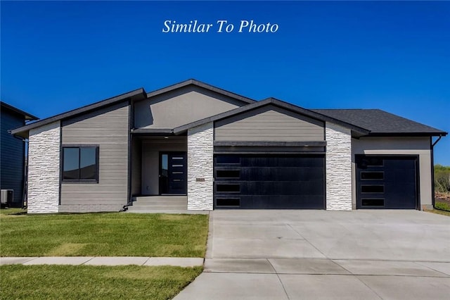 view of front of property with an attached garage, stone siding, and concrete driveway