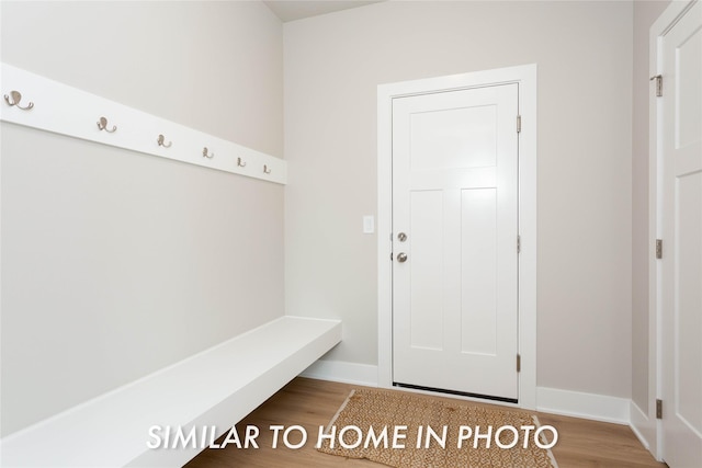 mudroom featuring baseboards and wood finished floors