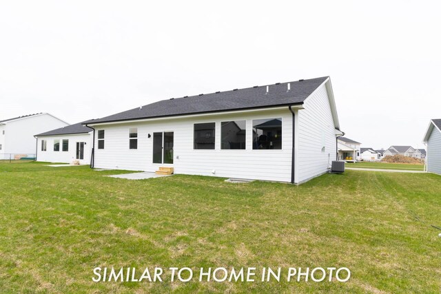 1020 2nd St NE, Altoona, IA 50009 - rear view of property with entry steps, a yard, and a shingled roof