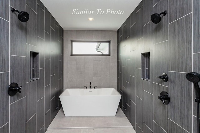 full bathroom featuring a freestanding bath and tile walls