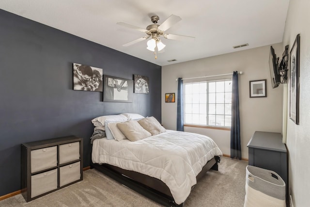 bedroom with baseboards, multiple windows, visible vents, and light colored carpet