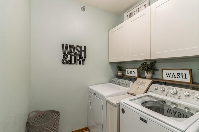 washroom with washing machine and dryer and cabinet space