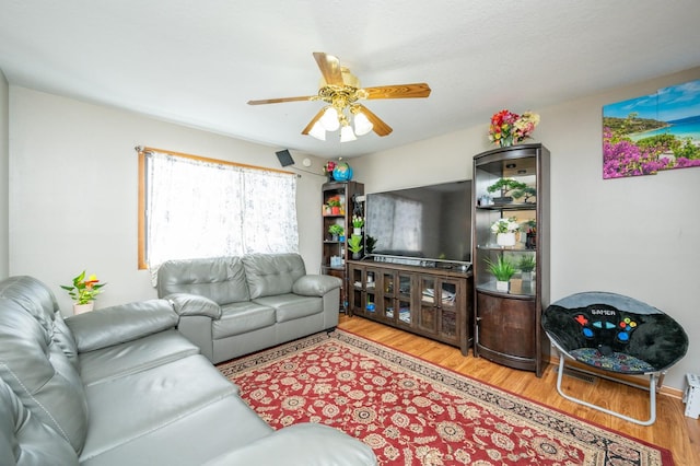 living area with ceiling fan and wood finished floors