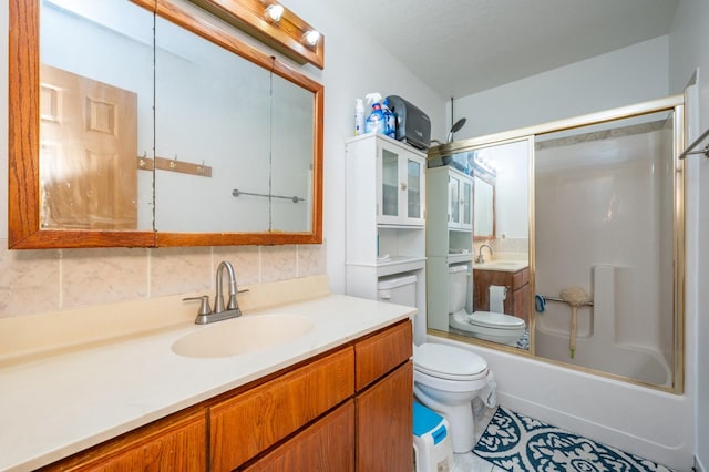 full bath featuring toilet, washtub / shower combination, backsplash, and vanity