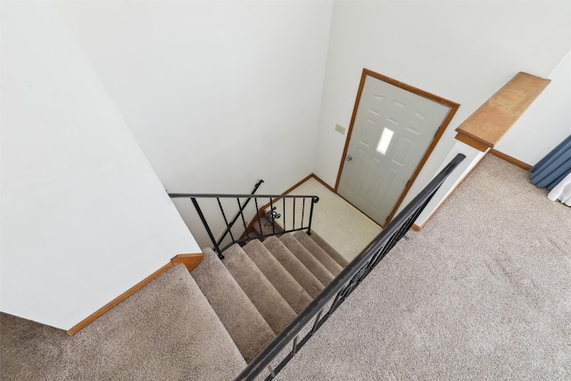 staircase with carpet floors and baseboards