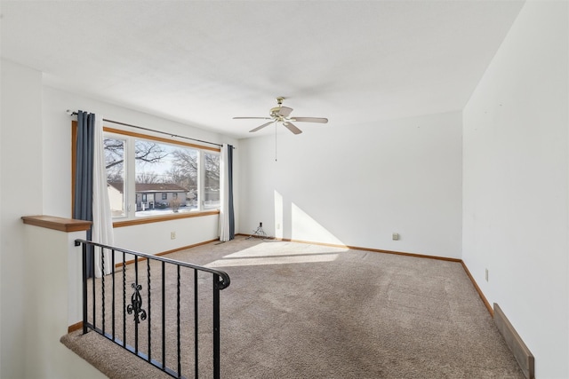 unfurnished room with carpet floors, ceiling fan, and baseboards