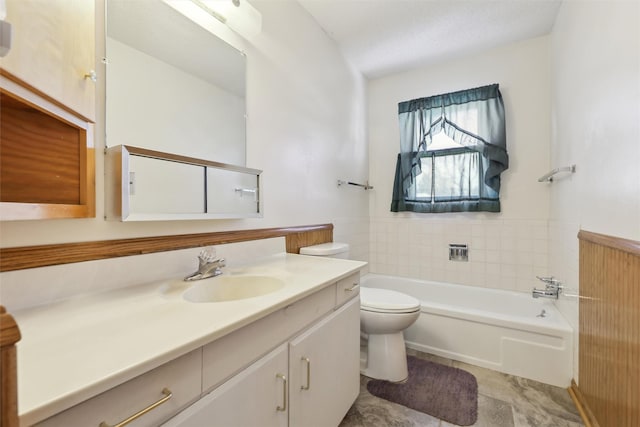 bathroom featuring a wainscoted wall, vanity, toilet, and a bath