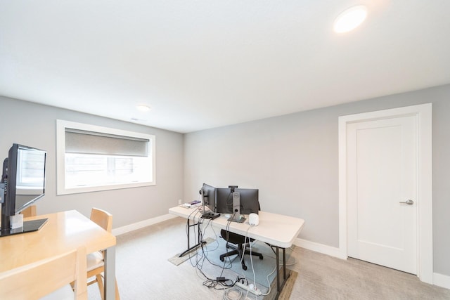 office space with baseboards and light colored carpet