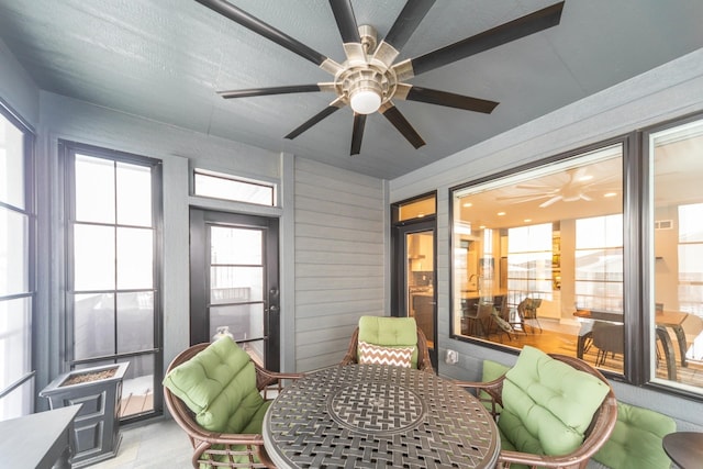 sunroom / solarium featuring ceiling fan