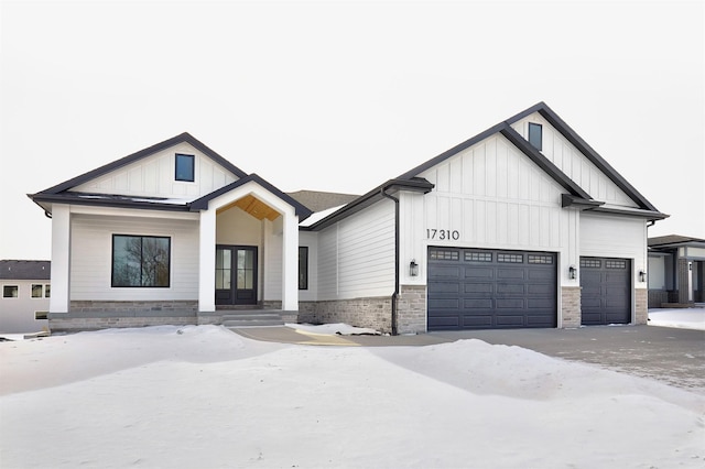 modern farmhouse featuring a garage, board and batten siding, and french doors