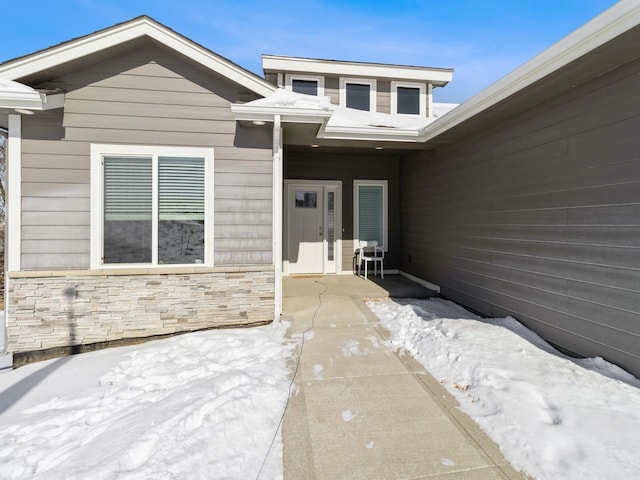 doorway to property with stone siding