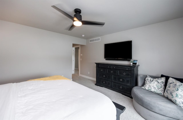 bedroom featuring baseboards, visible vents, a ceiling fan, and light colored carpet