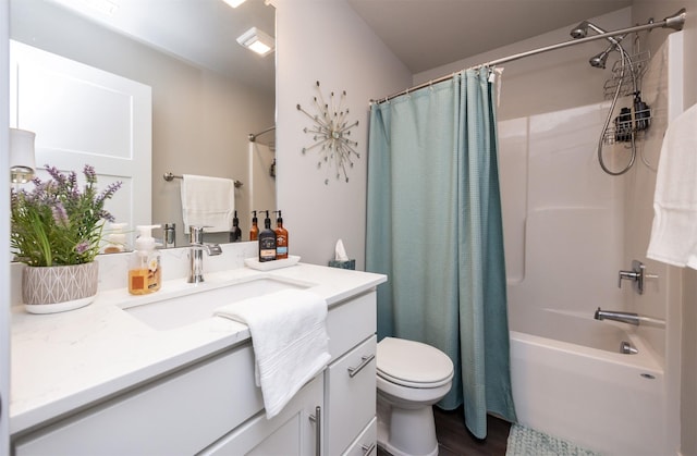 bathroom featuring toilet, wood finished floors, shower / bath combination with curtain, and vanity