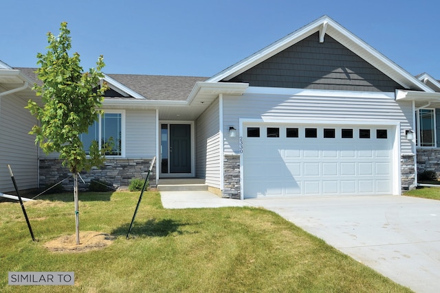 view of front of house with a garage, stone siding, and a front yard