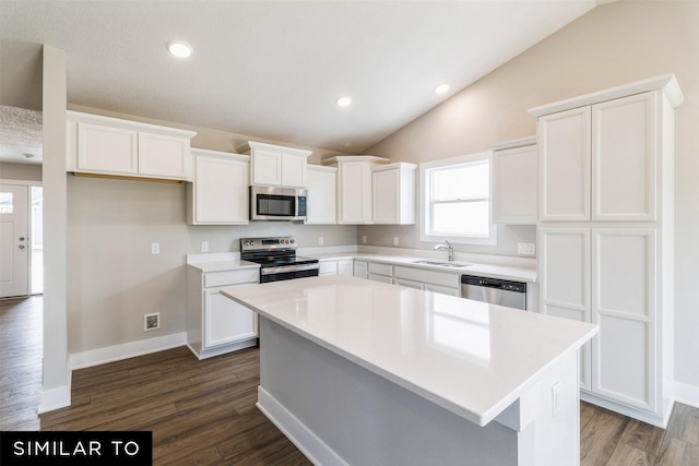 kitchen with a kitchen island, stainless steel appliances, and light countertops