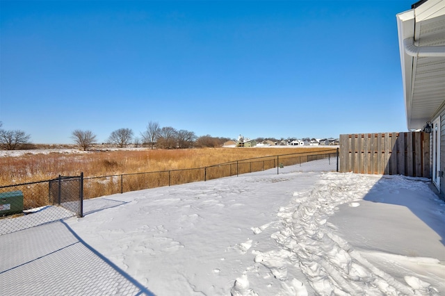 snowy yard with fence