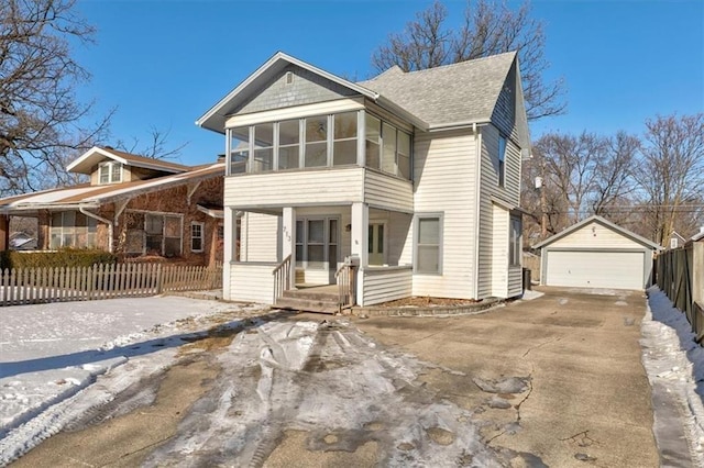 view of front of house featuring fence, a porch, a sunroom, an outdoor structure, and a garage