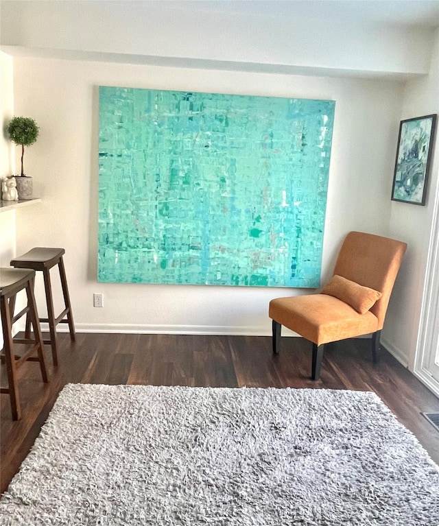 sitting room with dark wood-style floors and baseboards