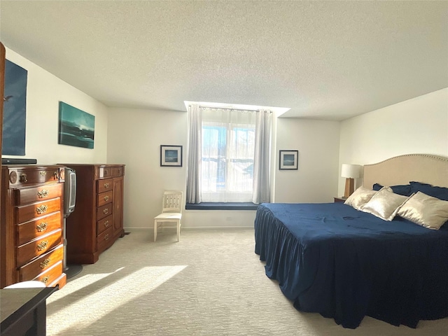 bedroom featuring a textured ceiling, baseboards, and light colored carpet